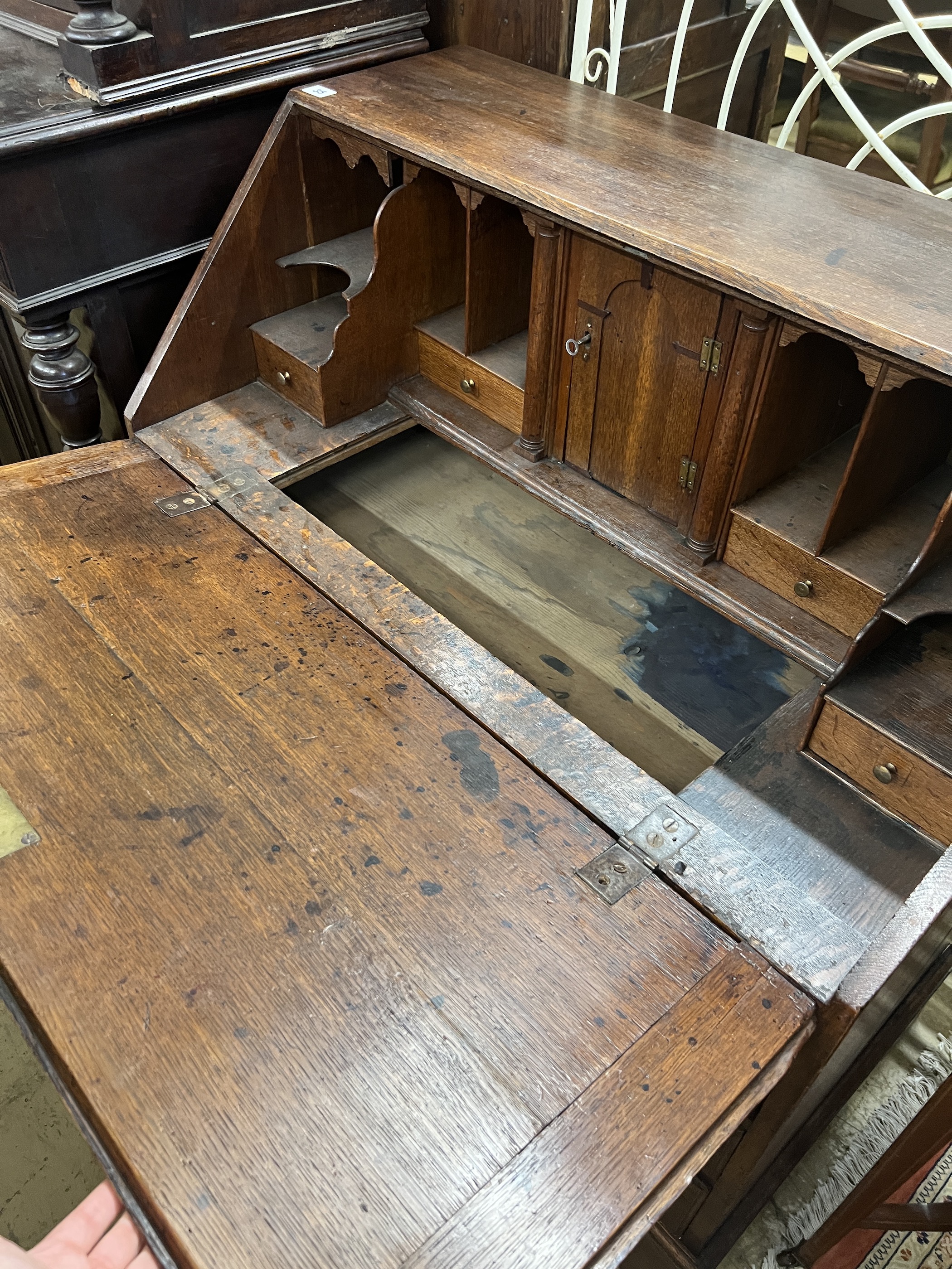 A George III oak bureau the interior with well, width 92cm, depth 53cm, height 101cm